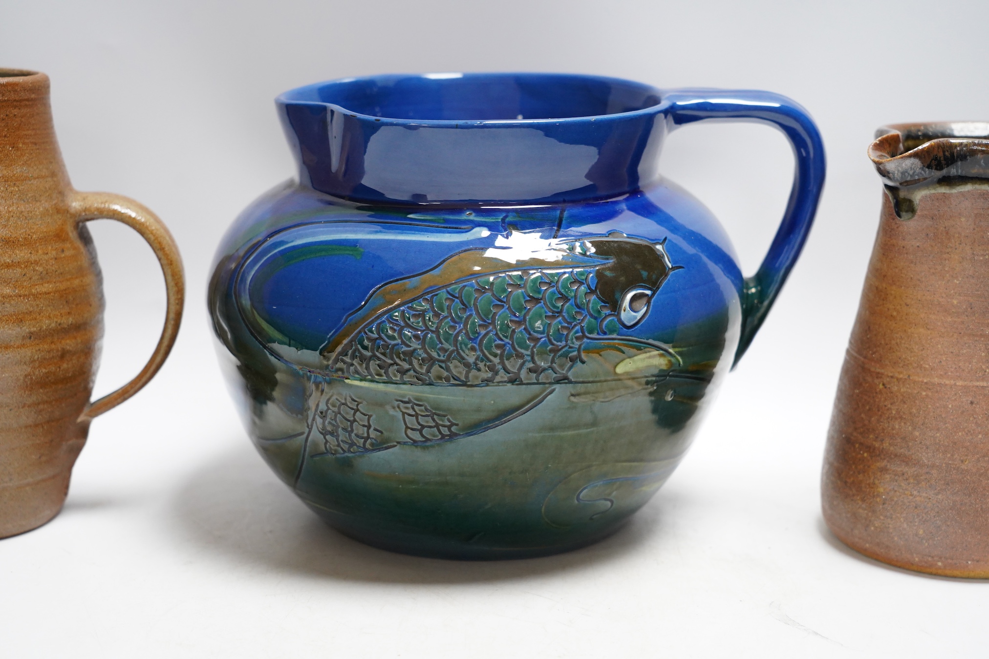 A group of six pottery jugs, to include GH Brannam, Muchelney and Bovey Tracey Art Pottery, largest 20cm high